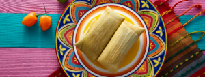 Plate of Tamales on a brightly color plate and tablecloth